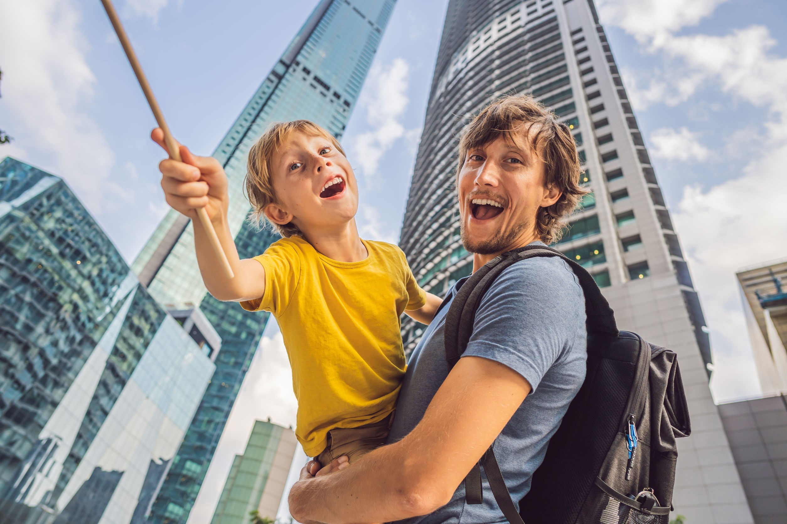 dad and son happy in city